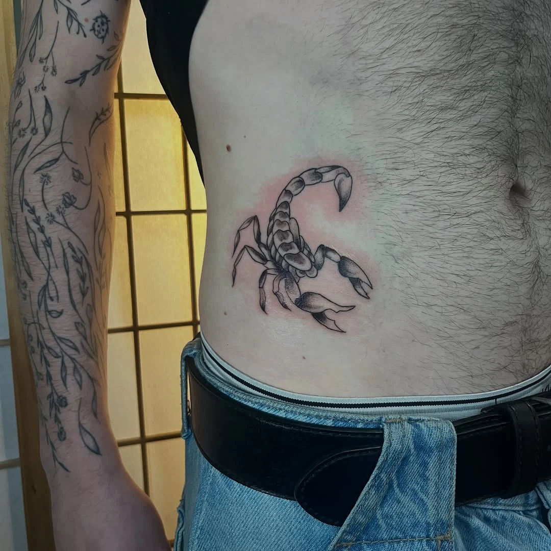 Petit tatouage fine line / stippling sur le ventre — pour Griffin.